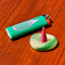 up close of pink droplet with green burner