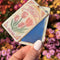 model holding cream compact with tulip seed pack design