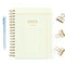 yellow and red grid 'notebook paper print' notebook with gold foil 'professional overachiever - in my organized era' across the front surrounded by pen and gold binder clips