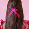 model wearing hot pink velvet hair bow clip