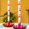 set of 2 pink dinner candles with all over cherry print on a table setting