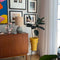 giant plastic ice cream cone planter with plant inside and placed in a living area