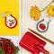patch keychain with red trim and white flower and strawberries on a notebook and gardening tools