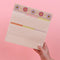 model holding cream desk pad with colorful retro floral print