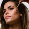 model putting studio tone spf 50 bronzing drops on her cheek