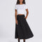 front view of model wearing flowy black midi skirt