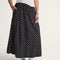 side view of model wearing black skirt with white polka dot print