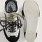 top and bottom view of black and metallic silver super low pro sneakers with black and white speckled laces and sage laces