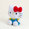side view of hello kitty wearing blue overalls and yellow top with her iconic red bow warmie plush