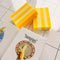 banana scented two toned yellow bar soap in a table