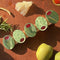 row of 5 sparkly olives on alligator hair clip on a table