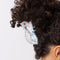 model wearing white Persian cat hair claw with pink bow on their neck