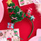 green tulle christmas tree with colorful bows, gold star and stacked christmas presents