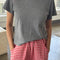 model wearing heather grey tee
