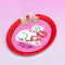 pink and red oval trinket tray with white cat and says 'portrait of a perfect little friend' with jewelry on it