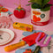 yellow 'double concentrated tomato paste' bottle opener surrounded by tomato items