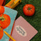 yellow 'double concentrated tomato paste' bottle opener peeking out of tomato print tote