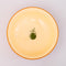 cream interior of red large ceramic serving bowl with light pink garden border and orange rim with green veggie inside