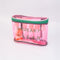 side view of pink and green plastic 'squeaky clean' travel kit with two pots, a funnel, mini spatula, one pump, one spray bottle and label sheet