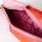 pink plaid interior of pink and red 'eraser' pencil case with cursive 'ready for anything' on the side