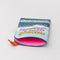 pink interior of passport holder with colorful mountain scene and 'greeting from paradise' across the front