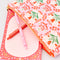 pink folk floral quilted pouch with a notepad and pens inside