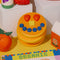 Front view of smiling pancake de stress ball with cute face design
