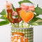 set of 4 plant stakes: orange heart, pink cowboy boot, brown horseshoe, and pink bow in a planter