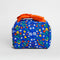 back view of cobalt blue toiletry bag with red bow handle and colorful folk floral print