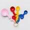 set of 4 stainless steel measuring spoons in pink, red, yellow and blue with squiggle handle on a ring
