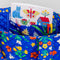blue quilted tote with colorful folk print with notebook inside
