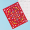 red monthly planner with colorful folk floral print on a blue ground