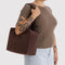 model carrying coffee everyday cloud bag