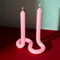 light pink twist candle on a red table