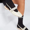 model wearing cream slingback flat with large grommet buckle and square toe