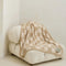 cream and khaki checkered blanket on a chair