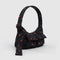 side view of black small cargo bag with two front patch pockets and red painted wildflower print