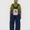 model wearing dusty pink mini backpack with black straps and trim