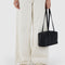 model holding black nylon bowler bag