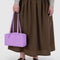 model holding rose rectangular nylon bowler bag with matching zipper and charm clasp