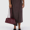 model holding medium mahogany recycled dome bowler bag with silver charm clasp