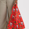model carrying coral standard baggu with western hello kitty with horse, cactus, lasso, and star print