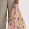 model holding pale pink standard baggu with fancy teddy bear print