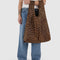 model holding dark brown leopard print big baggu