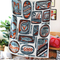 model holding white tea towel with orange and blue sardine can print