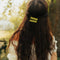 model wearing set of two green 'pyrex inspired' hair clips