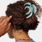 model wearing blue swirl large octopus hair claw