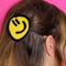 model wearing birdie wood collab yellow smiley hair clip in their hair