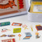 up close of tin with matchbook print with tiger with CREATIVE SPARK! across the front with matchbook sticker flakes