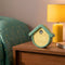 mint house shaped cuckoo digital clock with white cuckoo bird on a table